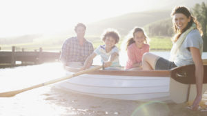 Family in rowboat on lake
